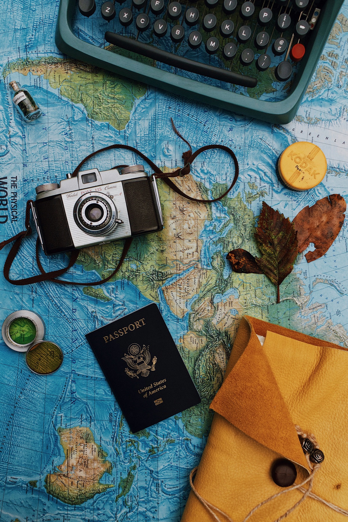 Passport, laptop and camera laid out for cruise planning