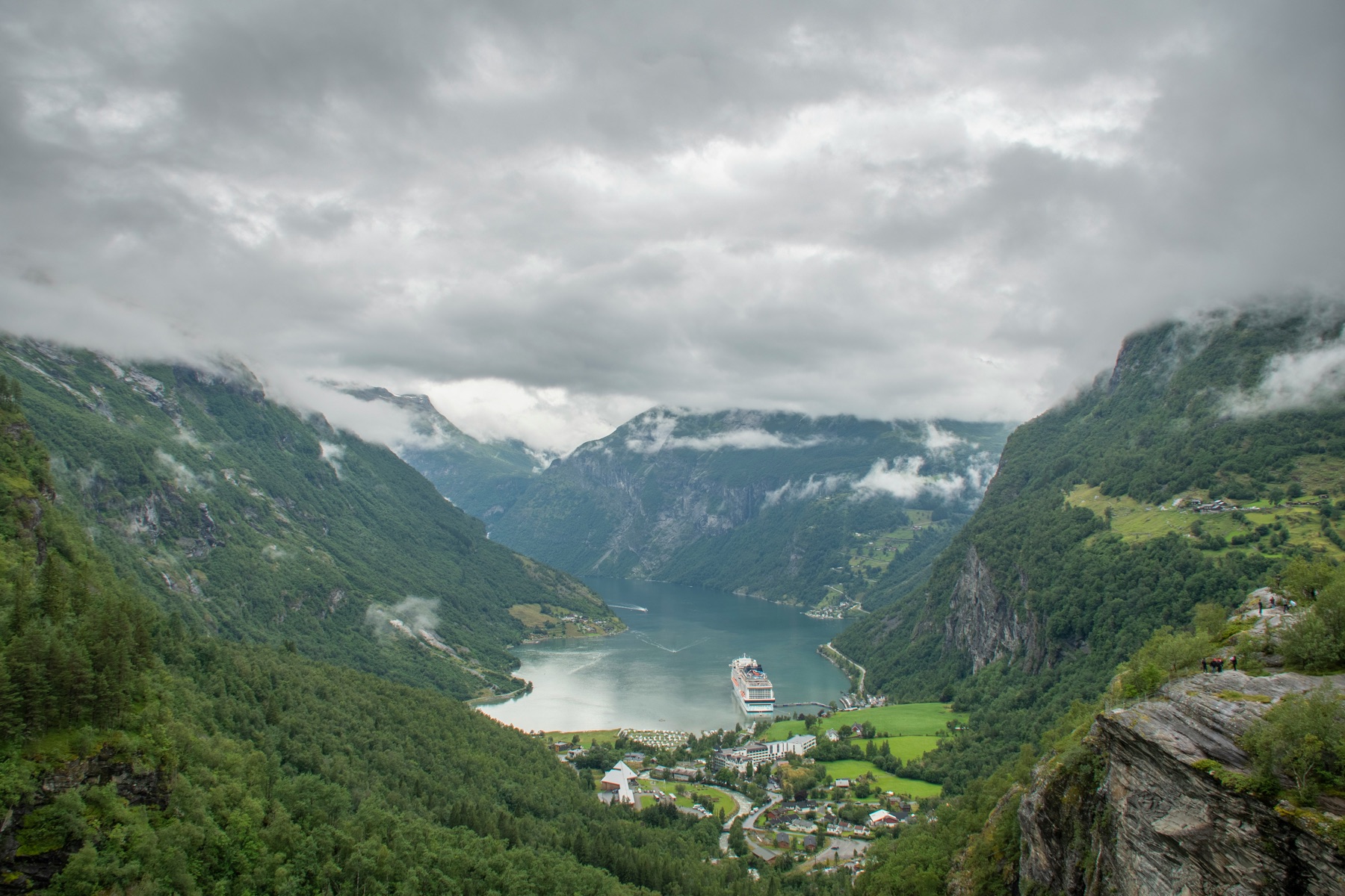 Cruise ship sailing through a Norwegian fjord