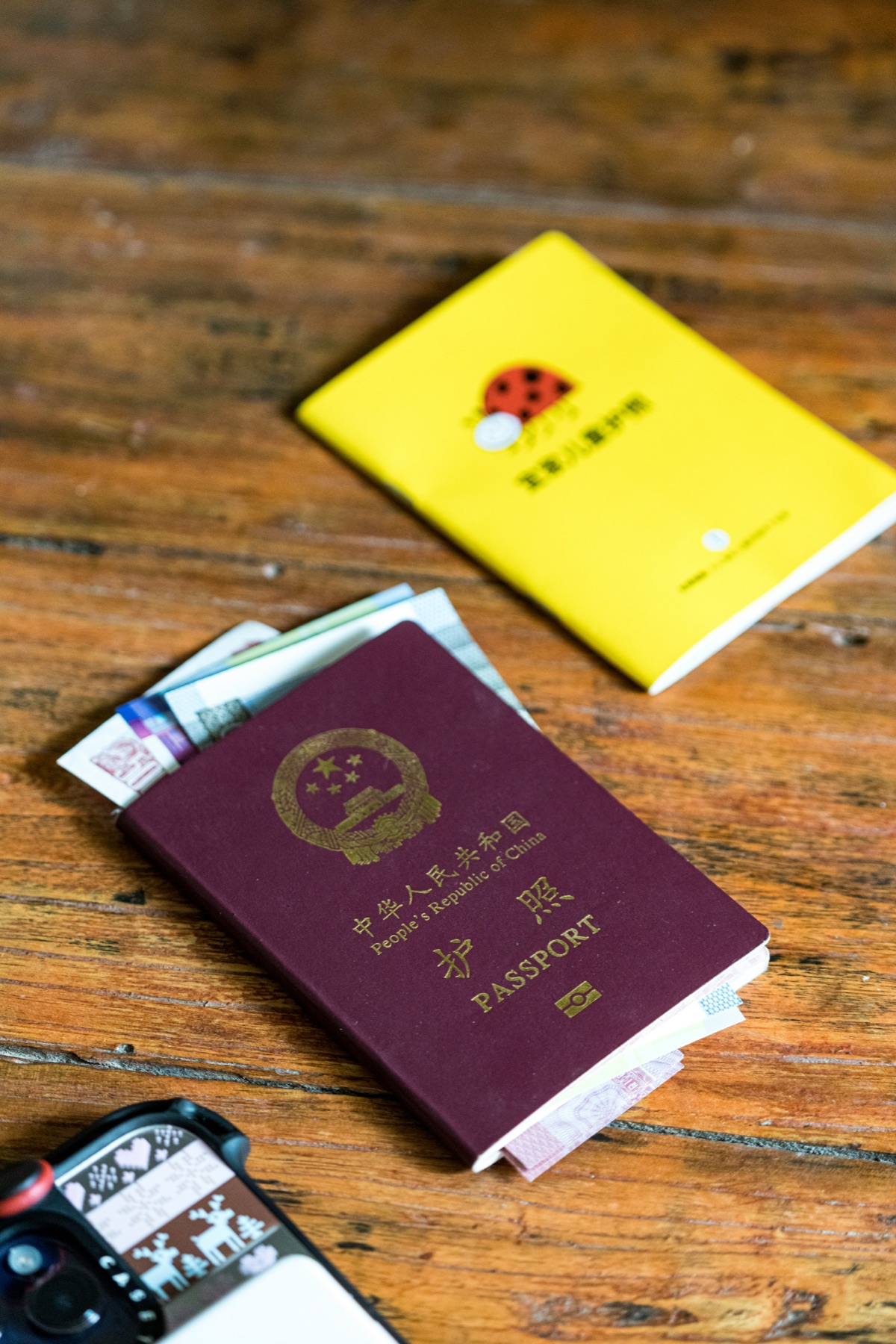 Passport and travel money on a wooden table