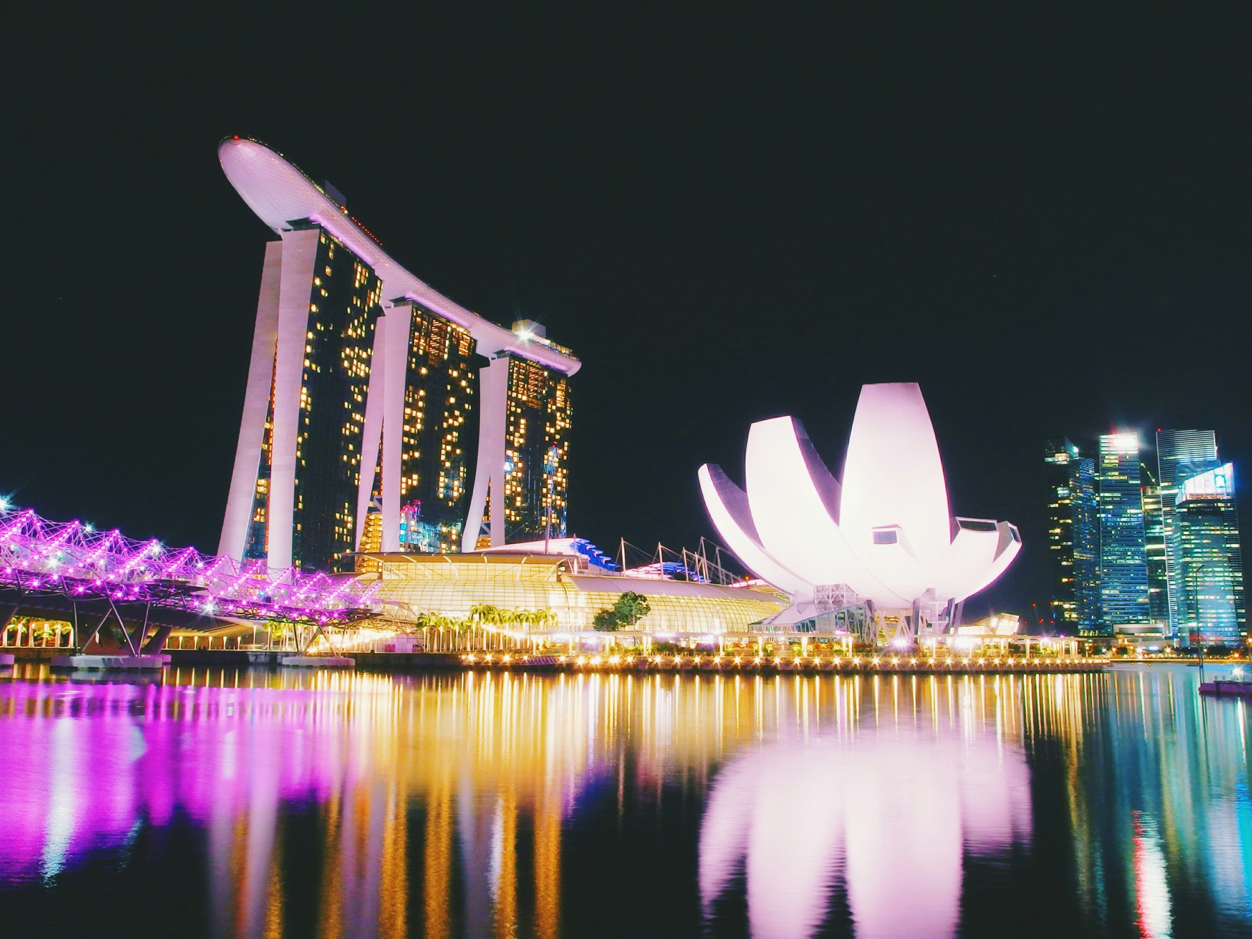 Singapore skyline reflected across Marina Bay at night